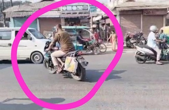 A Police officer was seen Biking on Agartala-Udaipur National Highway without Helmet