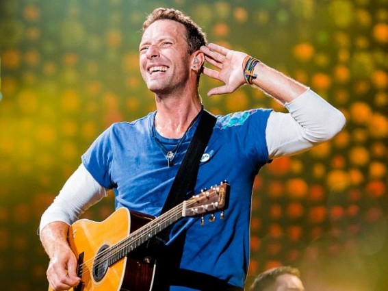 Chris Martin serves up coffee at homeless charity's shop