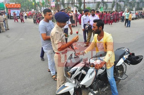 Agartala cops follow Gandhigiri  to convince bikers to wear helmets  