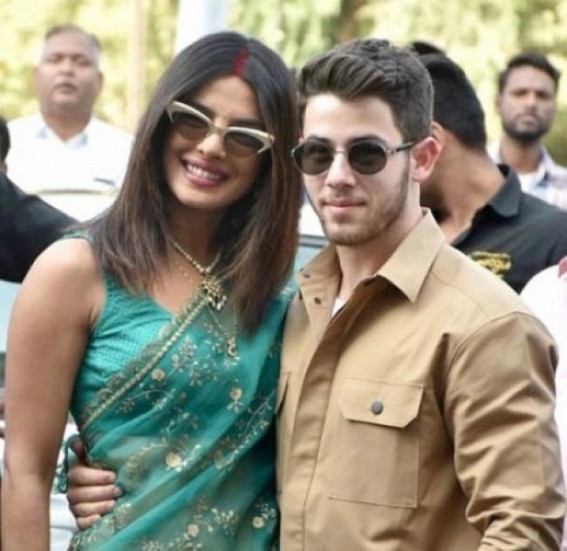 Priyanka trips, clasps Nick's arm, avoids fall Priyanka trips, clasps Nick's arm, avoids fall